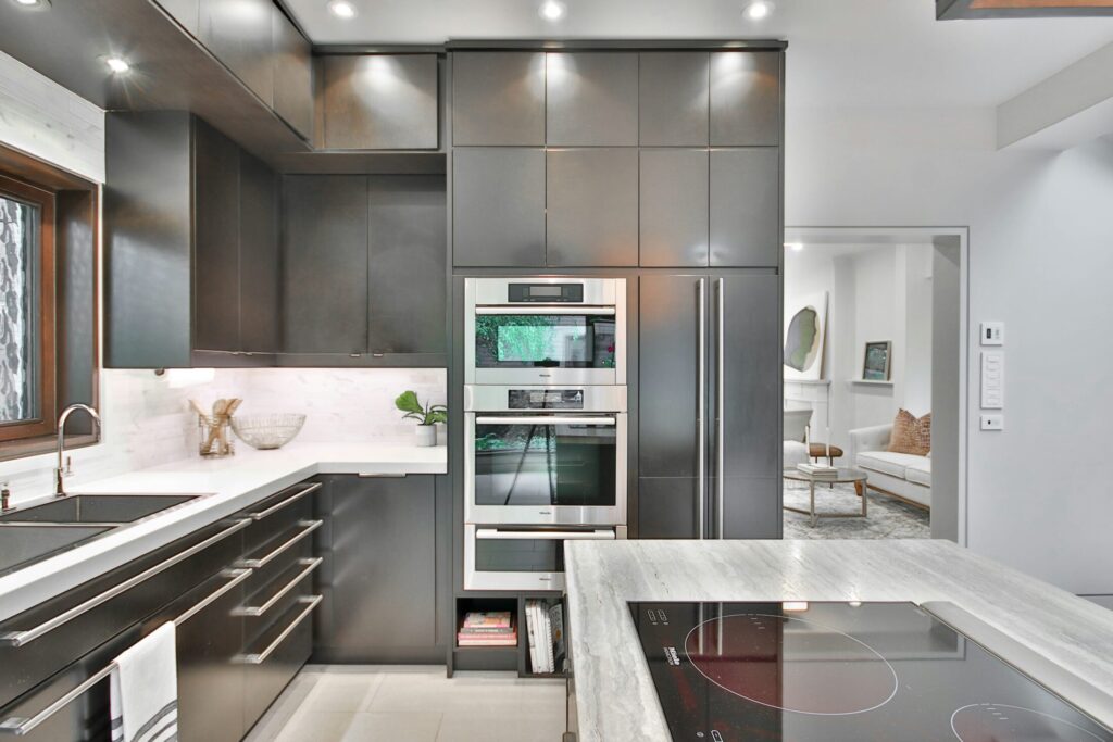 a modern kitchen with stainless steal appliances and marble counter tops