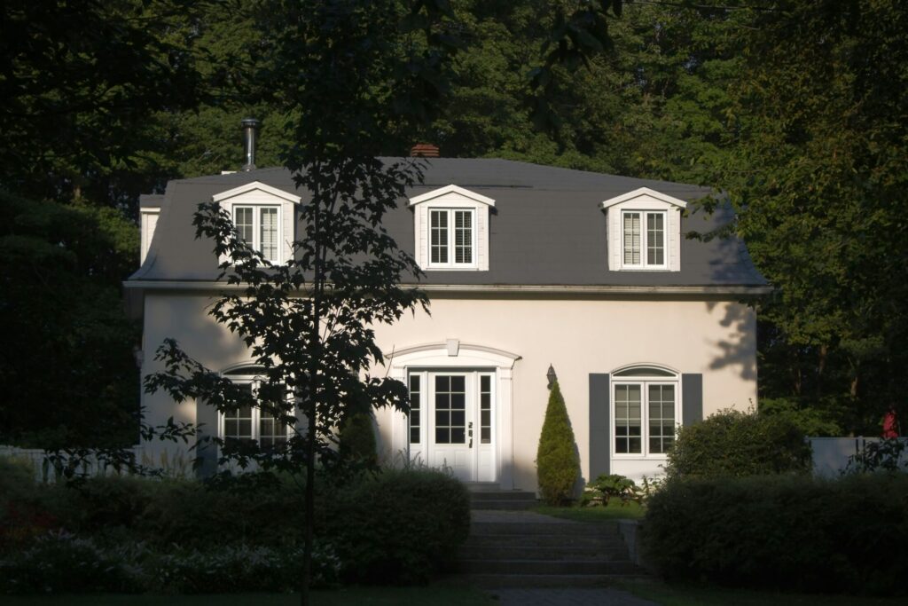 a charming house with dormer windows and shutters