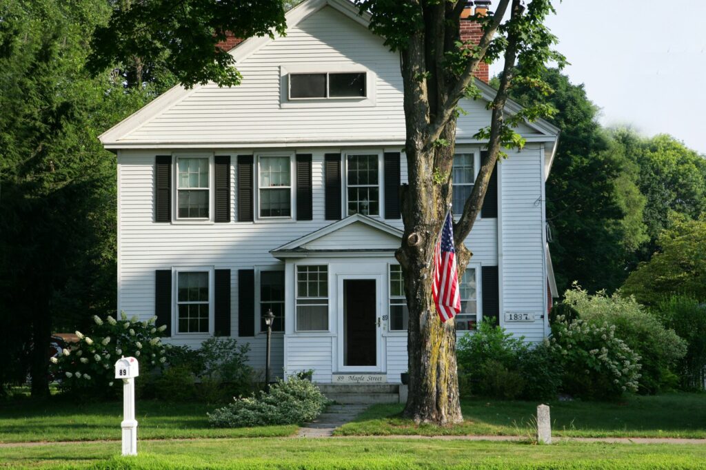 a white house with an american flag in front